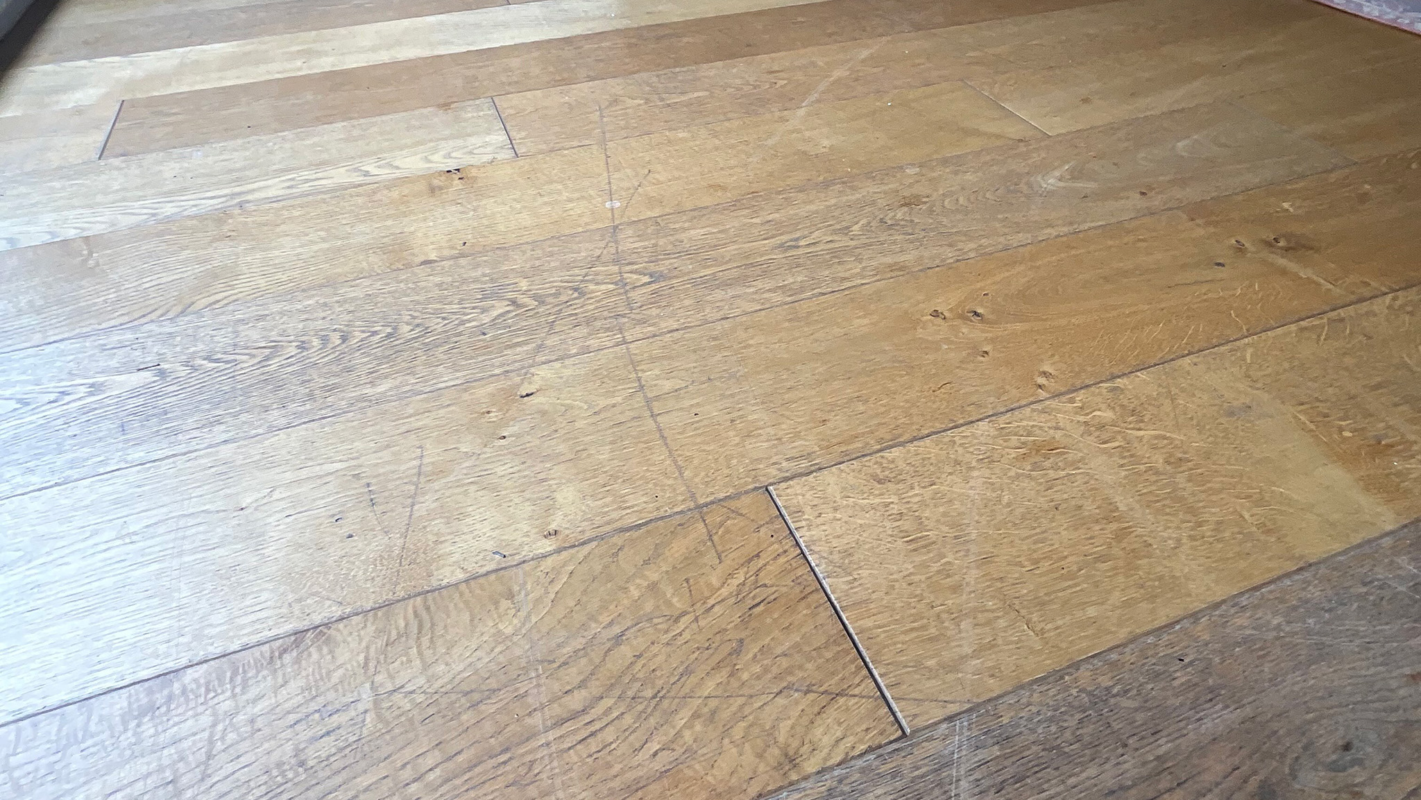 Before the transformation of an engineered wood floor - Harpenden