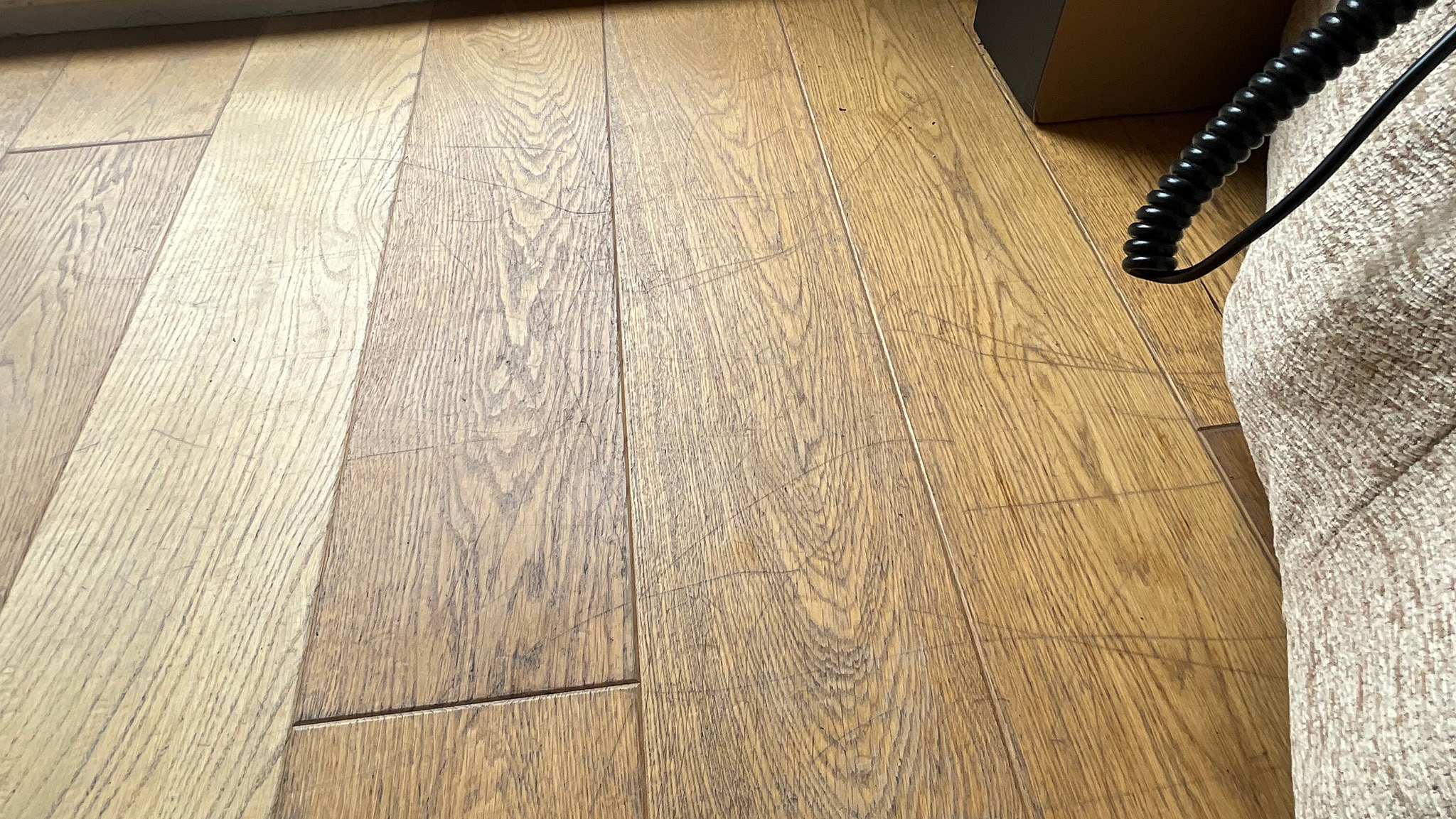 Before the transformation of an engineered wood floor - Harpenden
