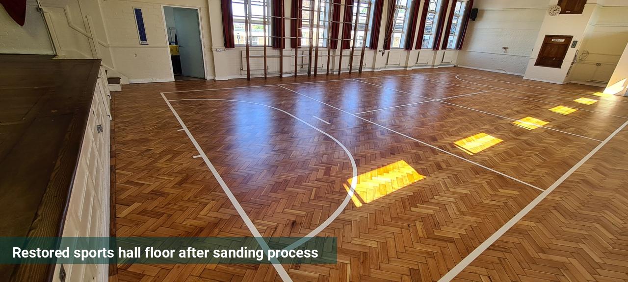 Restored sports hall floor after sanding process